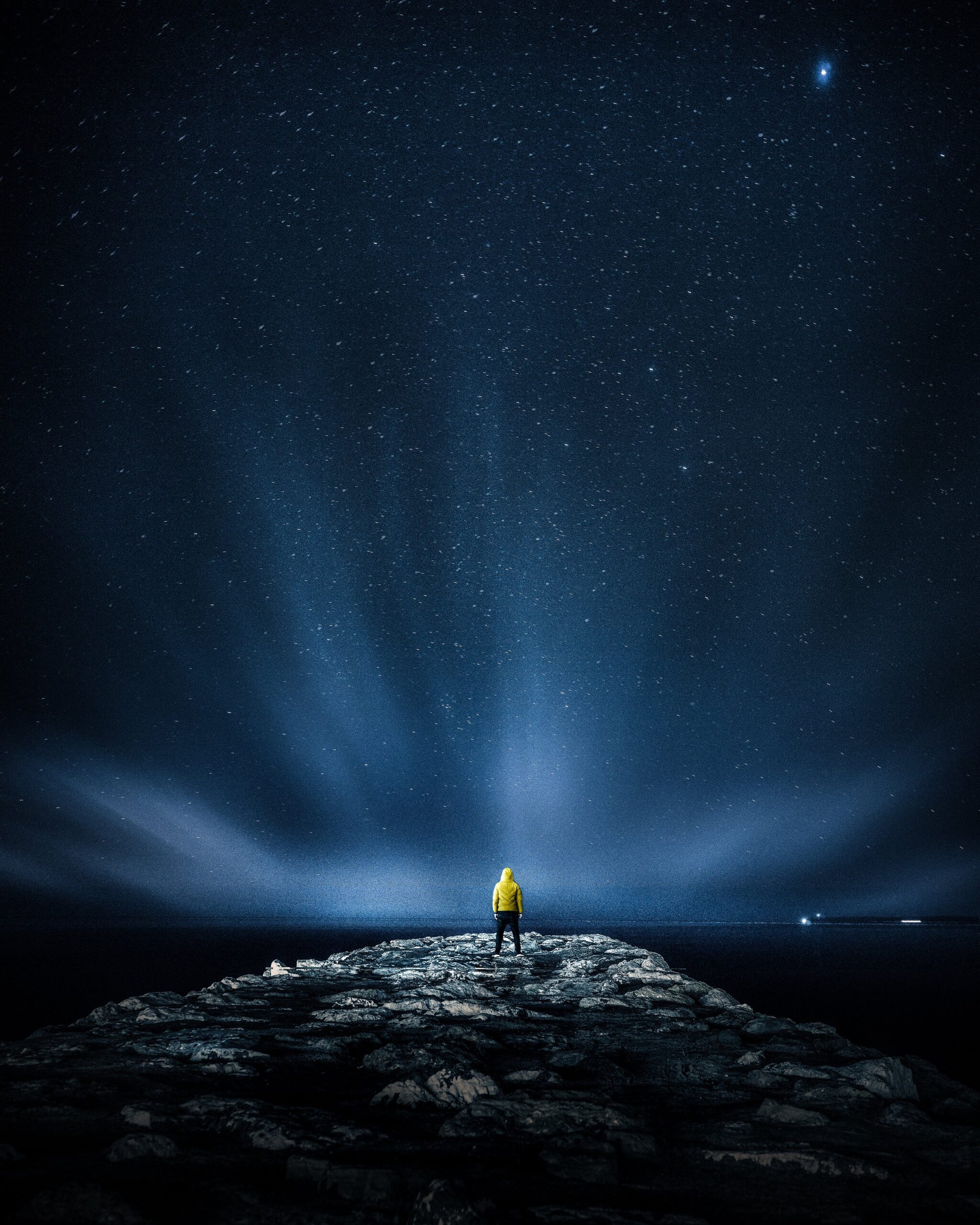 Person standing under starry sky representing spiritual wholeness and conscious creation
