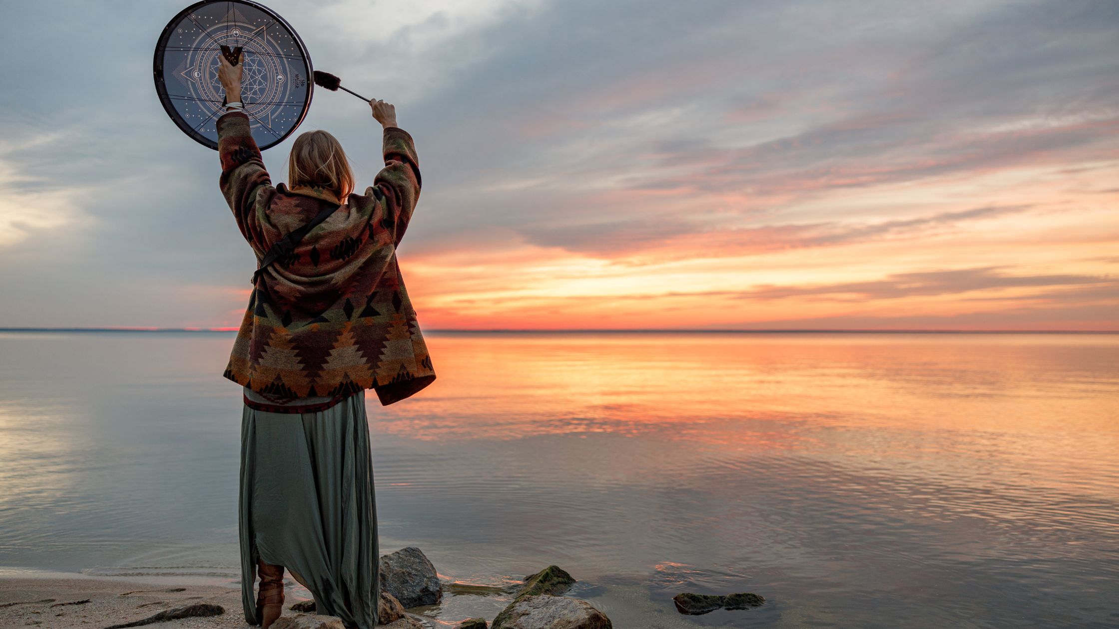 Woman dancing with shamanic drum Hero image for What is a shaman? Am I a shaman? How is Shamanic healing different from other modalities?