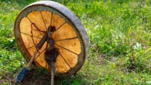 Shamanic drum lying in the grass Hero Image post on Am I a Shaman in the making? Signs You're Called to Be a Shaman