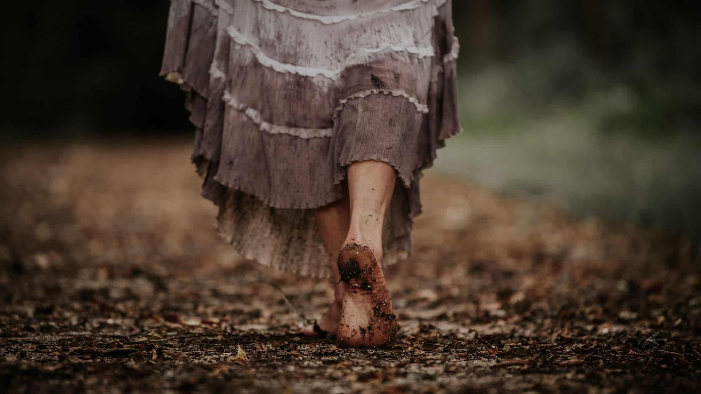 Embrace Your Villain Era: A Transformational Journey Person walking barefoot through a forest, embracing their villain era mindset and transformational journey toward personal growth and lasting habits.