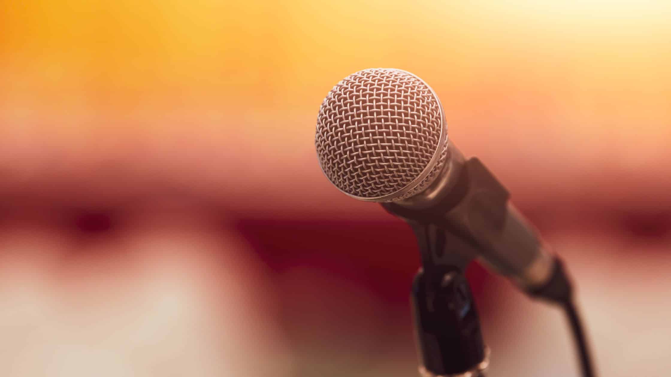 A professional microphone on stage, symbolizing public speaking and leadership.