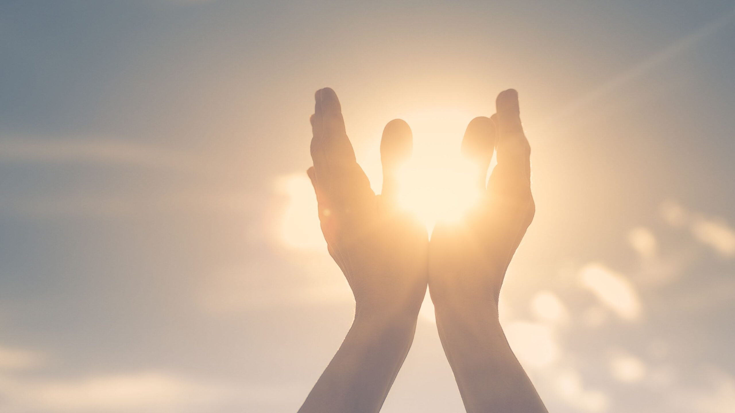 Hands lifted toward the sun, symbolizing spiritual gifts discernment and divine connection