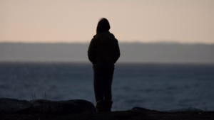 how to heal yourself emotionally &ndash; person reflecting by the ocean