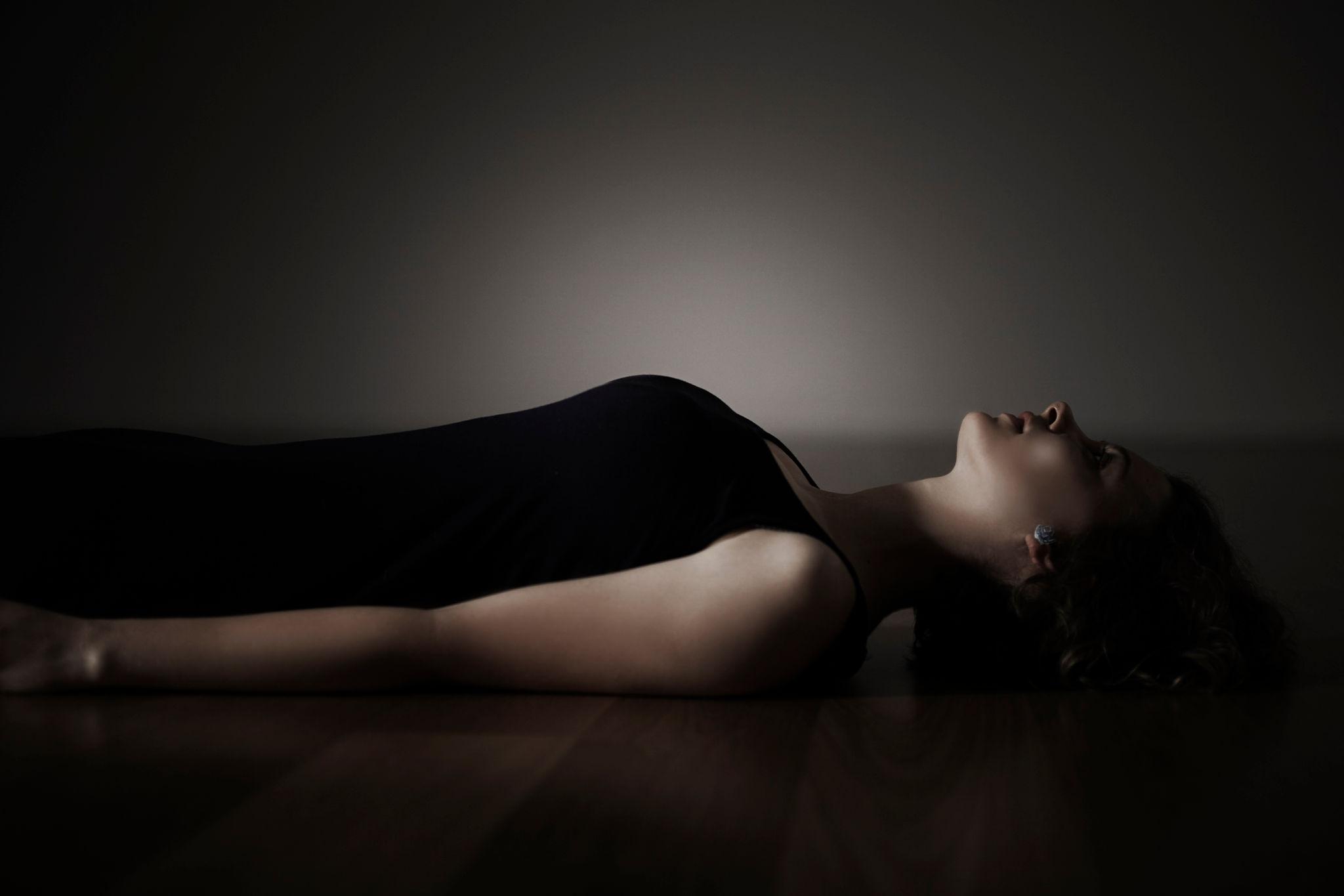 woman lying down but unable to relax during self healing journey and emotional overwhelm