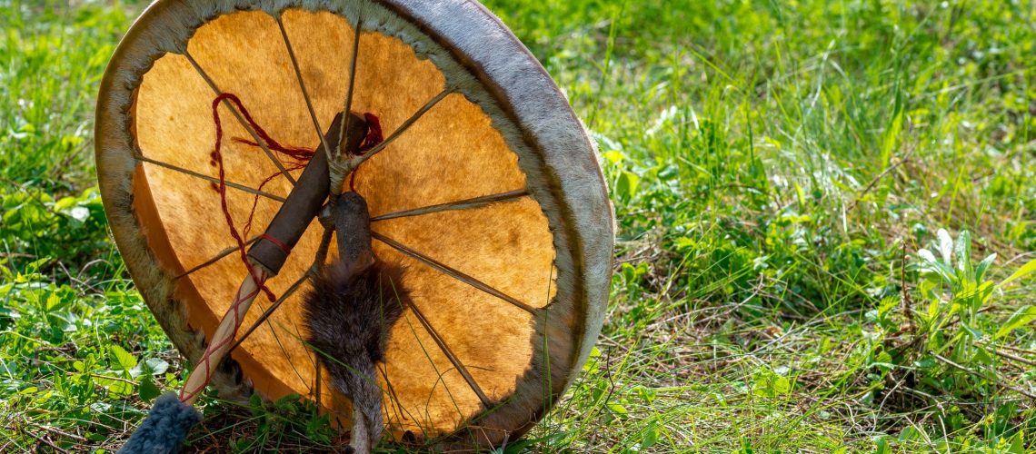 Shamanic drum lying in the grass Hero Image post on Am I a Shaman in the making? Signs You're Called to Be a Shaman