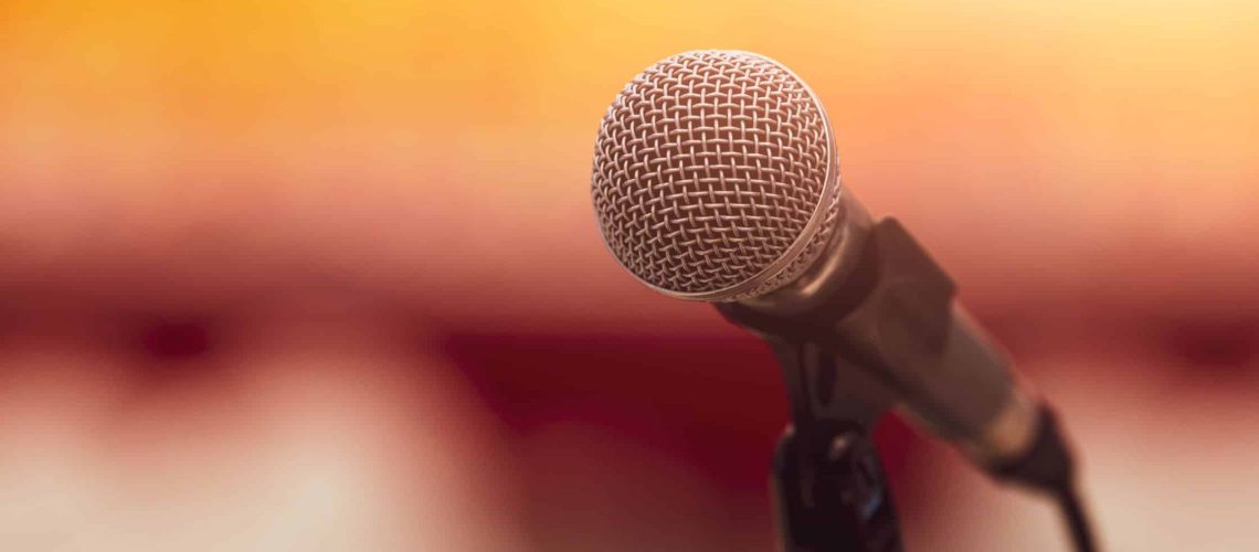 A professional microphone on stage, symbolizing public speaking and leadership.